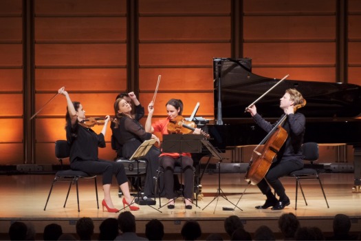 A piano quartet in action - however confusion is caused as the pianist asks the string players to indicate which one is going to be leading the piece, and they all put their hands up (though the viola player seems less keen)